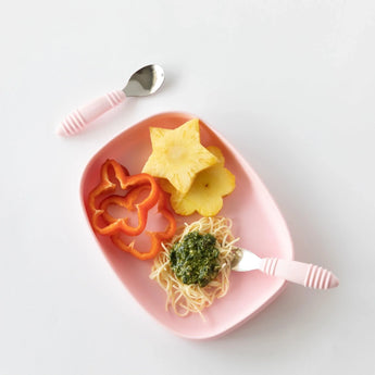 The Bumkins Pink Silicone Grip Tray includes star-shaped pineapple, red pepper slices, pesto spaghetti, a suction base, and pink utensils.