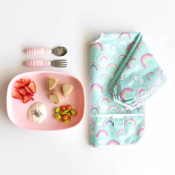 Bumkins Silicone Grip Tray: Pink set includes a plate with fruit & yogurt, utensils, and a rainbow-patterned bib for babys meal.