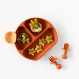 Silicone Little Dipper 3-Pack: Tutti-Frutti by Bumkins features an orange plate with hummus, bell peppers, kiwi, snacks + utensils.