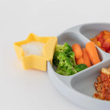 The gray divided plate has fun food shapes, and the star-shaped dish holds a Little Dipper from Bumkins Silicone Tutti-Frutti pack.