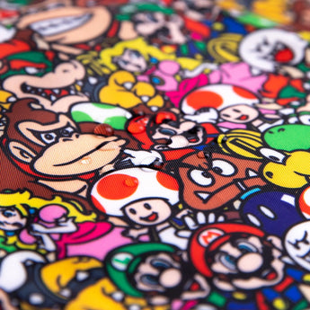 SuperBib® 3 Pack by Bumkins: Waterproof bibs with vibrant Nintendo icons like a brown ape and red-capped plumber.