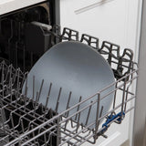 Open dishwasher with a single gray plate on a Bumkins Silicone Sensory Placemat in the top rack.