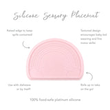 Bumkins Silicone Sensory Placemat: Pink with rainbow design, raised edge for spills, and roll-up feature for play and portability.