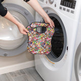 Person places a colorful patterned bag in a front-load washer, just as you would the Bumkins SuperBib® 3 Pack: Super Mario™ Power-Up.