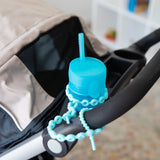 Blue Silicone Accessory Tether by Bumkins secures a sippy cup to a stroller handle.