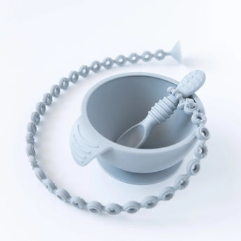 Gray Silicone Accessory Tether Pack by Bumkins: includes a bowl, spoon, beaded strap, and suction cup for sensory exploration.