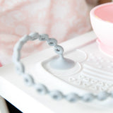 Close-up of Bumkins Gray Silicone Accessory Tether on a high chair, ideal for sensory exploration with its textured beads.