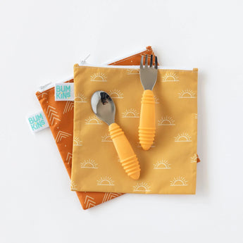 Get a Bumkins 2-pack reusable snack bag set featuring Sunshine & Grounded designs. Easy-clean, waterproof fabric with orange utensils.