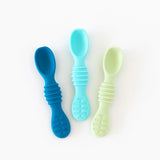 Bumkins Silicone Dipping Spoons 3 Pack in Gumdrop, featuring dark blue, light blue, and pale yellow textured silicone handles.