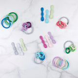 Bumkins Silicone Dipping Spoons & Rings in Taffy colors scattered on marble—safe, playful designs for babies.