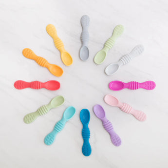 Bumkins Silicone Dipping Spoons in Tutti-Frutti shown in a circular layout, ideal for self-feeding.