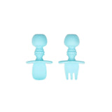 Two blue Bumkins Silicone Chewtensils® for baby-led weaning, with sensory bumps, wide grips, and small handles on a white background.