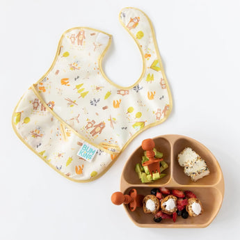 Clay Chewtensils® by Bumkins with a baby bib & divided plate of fruits, veggies, and sandwiches—ideal for baby-led weaning fun!.