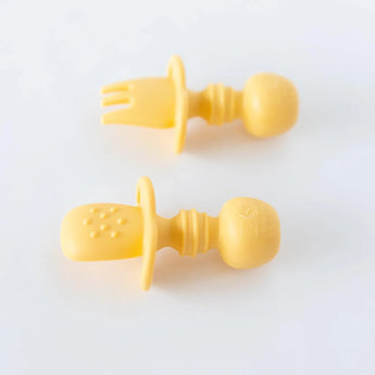 Bumkins Pineapple Silicone Chewtensils®: A yellow fork and teething spoon for babies, food-safe with handles, on a white background.