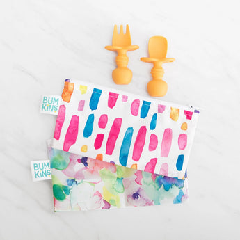 Two Tangerine Silicone Chewtensils® & two Bumkins abstract snack bags on white. Perfect for baby-led weaning.