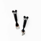 Bumkins Spoon + Fork: Mickey Mouse set features cartoon handles with mouse ears, crafted from food-safe silicone on a white backdrop.