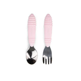 The Bumkins Spoon + Fork: Pink set features a pink-handled, ergonomic design for kids self-feeding against a white background.