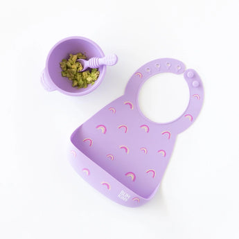 Bumkins Purple Silicone Bib: Rainbows is perfect for mess-free meals with its matching bowl and spoon containing mashed food.