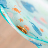 A close-up of Bumkins turquoise lunch bag with ocean life designs, waterproof fabric, and pretzel sticks included.