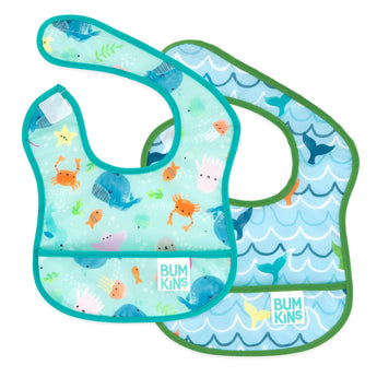 Two colorful Bumkins Starter Bibs with marine animals and wave patterns, waterproof and machine washable. Ocean Life & Whale Tail.