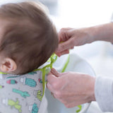 Bumkins Sleeved Bib: Cacti features adjustable fit and waterproof fabric, making mealtime mess-free for your little one.