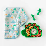 Bumkins Sleeved Bib: Dinosaurs with green dino plate/utensils on white, perfect for baby-led weaning.