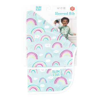 Packaging for the Bumkins Sleeved Bib: Rainbows, displaying a rainbow and cloud design on blue. Made with stain and odor-resistant waterproof fabric, ideal for baby-led weaning. A child wearing the bib is pictured on the packaging. Suitable for ages 6-24 months.