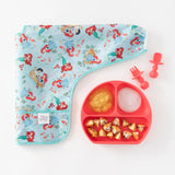 Bumkins Sleeved Bib: Ariel with a red divided plate of purees and matching utensils on a white background.