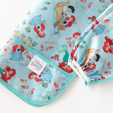 Bumkins Sleeved Bib: Ariel with Prince Eric and sea creatures on light blue. Perfect for little mermaid fans!.