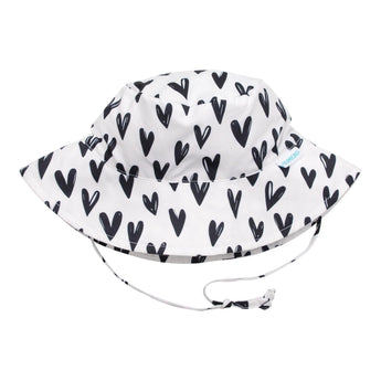 Bumkins Sun Hat: Hearts, white with black hearts, adjustable chin strap, UPF 50+ fabric for sun protection.