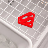 The Bumkins Silicone Teether: Superman rests on a rack over ice cubes, ideal for soothing baby gums.