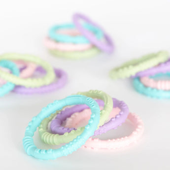 Bumkins Silicone Teething Rings 4 Pack: Spring, crafted from food-safe silicone, soothes gums with pastel hues on a white backdrop.