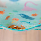 The Bumkins Junior Bib: Ocean Life features a waterproof ocean-themed design, complete with sea creatures like fish and jellyfish.