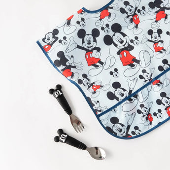 Bumkins Junior Bib: Mickey Mouse Classic, paired with a fork and spoon with Mickey handles, featured on a white background.