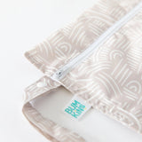 The Bumkins Wet Bag: Wander is a beige waterproof pouch with white abstract patterns and a handle for versatile use.