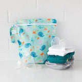 Bumkins Wet Bag: Ocean Life features waterproof fabric, teal and gray cloth diapers, plus a breast milk collection shell.