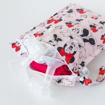 Bumkins Wet Bag: Minnie Mouse Classic - pink bag with cartoon mouse and red bows, made of waterproof fabric for organizing breast pump parts.