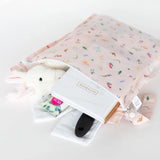 Open Wet Bag: Princess Magic by Bumkins, featuring a stuffed bunny, notebook, brush & more. Ideal for keeping items safe and dry.