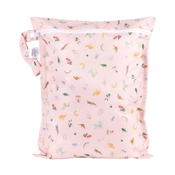 The Bumkins Wet Bag: Princess Magic is pink with a white zipper, featuring animals, plants, and celestial symbols on waterproof fabric.