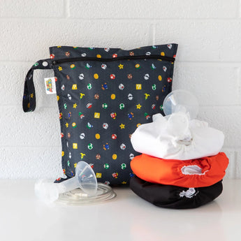 A Super Mario™ Lineup wet bag by Bumkins containing a breast pump and 3 waterproof cloth diapers in white, orange, and black.