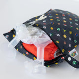 A Bumkins wet bag from the Super Mario™ Lineup holds cloth diapers and breast pump parts, made with waterproof fabric.