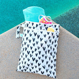 The Bumkins Wet/Dry Bag: Hearts is waterproof, reusable, and perfect for holding towels and swimwear by the pool.