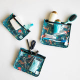 The Bumkins Clear Travel Bag 3-Pack: Jungle is TSA compliant for toiletries and grooming items with teal patterns on a white surface.