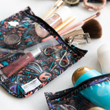 Bumkins Clear Travel Bag 3-Pack: Colorful, abstract TSA-compliant bags with words like kindness, perfect for cosmetics and brushes.