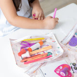 A child draws with a pink marker beside an opened Princess Magic Clear Travel Bag by Bumkins, filled with colorful pens.