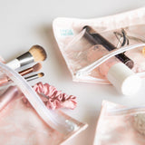 Open Clear Travel Bag 3-Pack: Lace by Bumkins with brushes, scrunchie, spray bottle, and cosmetics on a white surface.