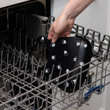 Placing a Bumkins Silicone Bib: Mickey Mouse Faces in the dishwashers top rack.